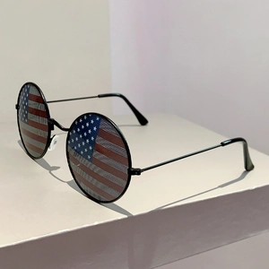 Close-up of round metal sunglasses featuring a unique US flag pattern on the lenses
