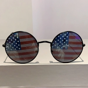 Detailed view of round sunglasses featuring US flag pattern on lenses with black frame