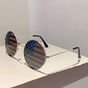 Detail of silver metal frame round sunglasses with US flag pattern lenses and black tips
