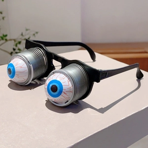 Lunettes rigolotes d'Halloween avec yeux à ressort et pupilles bleues sur cadre noir