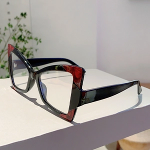 Close-up of cat-eye frames with red marble pattern and clear anti-blue light lenses