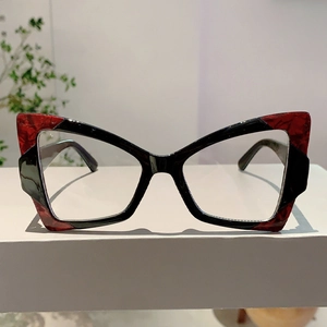 Detailed front view of black and red cat-eye glasses frame with tortoise pattern
