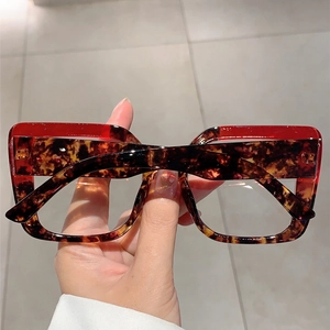 Detail of tortoise shell square frames with red translucent top accent and sturdy hinges