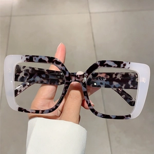 Detail of square glasses frame showing two-tone black tortoise and white acetate texture