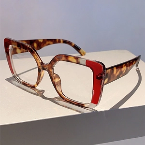 Detail of square tortoiseshell glasses with stylish red and white stripe accents