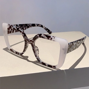 Close-up of square blue light glasses featuring grey marble and milky white frames