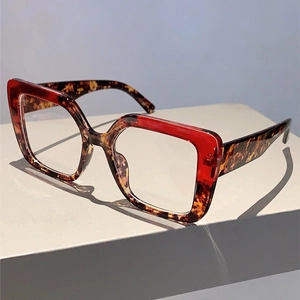 Detailed view of square oversized anti-blue light glasses with red and tortoiseshell frame