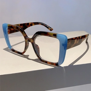 Detail of square oversized glasses frame with tortoise shell and blue translucent contrast