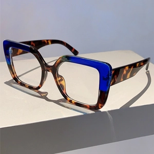 Detail view of square blue and tortoise shell glasses frame on minimalist geometric display