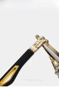 Detailed close-up of golden metal frame hinges with shield logo on black temples
