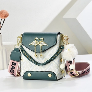 Green leather and canvas mini crossbody bag with gold swan clasp and plush charm accessory