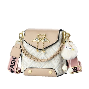 Mini beige flap crossbody bag with swan heart buckle and pink woven shoulder strap