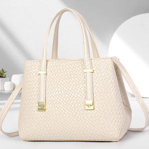 Detailed side view of cream-white crossbody bag with woven texture and gold buckle detail
