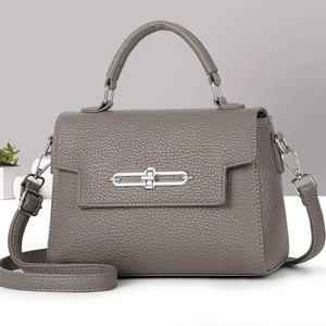 Close-up of grey-purple lychee grain leather handbag with silver chain buckle detail