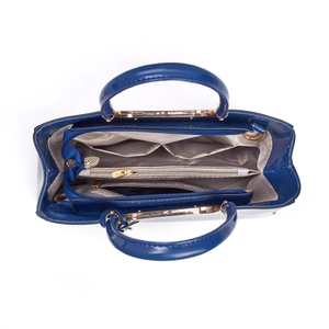 Top view of the spacious navy blue patent handbag interior with triple compartment design