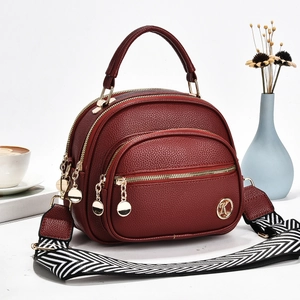 Burgundy lychee pattern crossbody bag with wide geometric strap and metal logo
