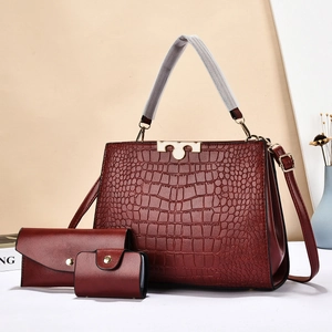 Three-piece burgundy faux leather tote set with crocodile pattern and gold hardware