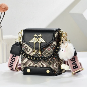 Mini crossbody bag with swan gold buckle and wide pink nylon strap in minimalist setup