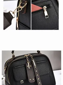 Detail of black lychee grain leather crossbody bag with golden metal hardware accents