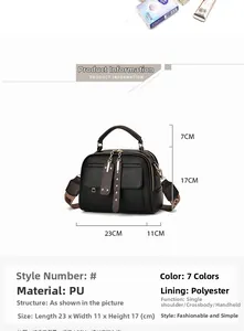 Close-up of black lychee grain PU Boston bag with gold hardware and wide print strap