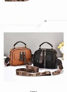 Detail of brown and black leather handbags with tassel charms and jacquard shoulder straps