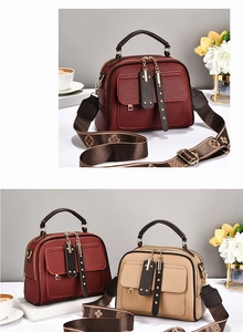 Detail of burgundy and khaki PU leather bags with jacquard straps and metallic buckles