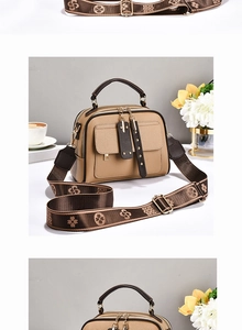 Detail of beige lychee textured handbag with retro floral jacquard wide strap and gold hardware