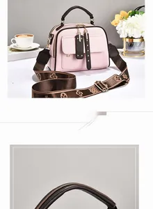 Detail of pink lychee leather bag with wide floral strap and golden hardware