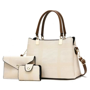 Ensemble de trois sacs en toile beige avec poignées et bandoulière en cuir marron