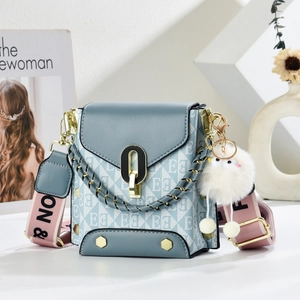 Blue-grey crossbody square bag with letter pattern, wide woven strap and plush charm