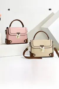 Close-up of retro underarm bag showing woven stitching detail and golden metal lock buckle