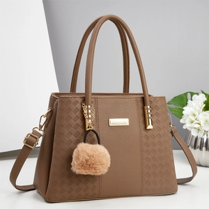 Brown lychee leather handbag with diamond stitching and plush ball charm for women