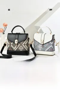 Detail of minimalist tote bags with geometric patterns and metallic hardware accents
