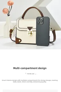 Detail of cream square crossbody bag with texture lock and multi-compartment interior