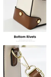 Detail of gold metal protective studs and spring hook on the leather crossbody bag