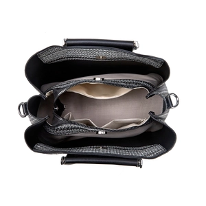 Internal view of a black leather tote with multiple compartments and silver hardware