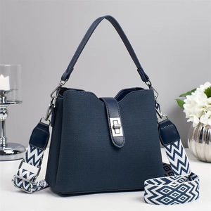Navy blue soft leather bucket bag with woven texture strap and metallic twist lock