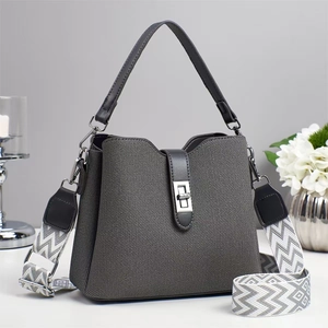 Detailed view of grey woven bucket bag with stylish geometric pattern wide fabric strap