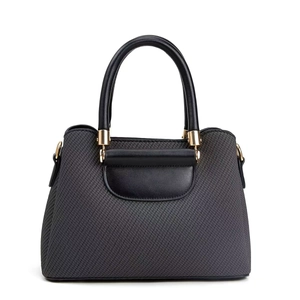 Detail of grey woven texture handbag with black leather handles and gold metal buckles