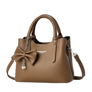 Brown litchi grain tote bag with pearl bow pendant and adjustable shoulder strap