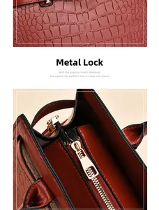 Détail du verrou doré et de la texture crocodile sur le sac à main rouge en cuir
