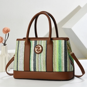Vertical stripe woven tote bag with brown leather trim and golden circular metal emblem