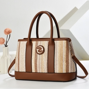 Brown and beige woven bucket bag with leather handles and gold logo on geometric background