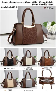 Detail view of leopard print panel handbag with gold hardware and internal zip compartment