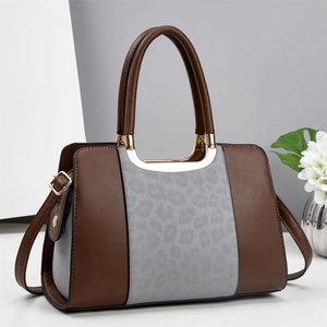Fashionable leopard print tote bag with brown handles and gold-tone hardware accents