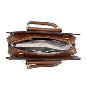 Interior view of brown leather handbag with multiple compartments and herringbone lining