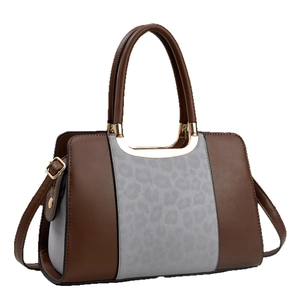 Fashionable brown leather tote bag with leopard print panel and golden hardware