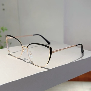 Detailed side view of cat-eye glasses with black and gold metal spring hinges