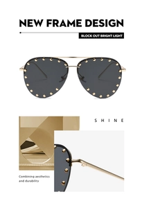 Detailed macro view of gold pilot sunglasses frame with rivet stud decorations