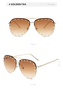 Detail view of gold aviator sunglasses with tea gradient lenses and rivet studded edges